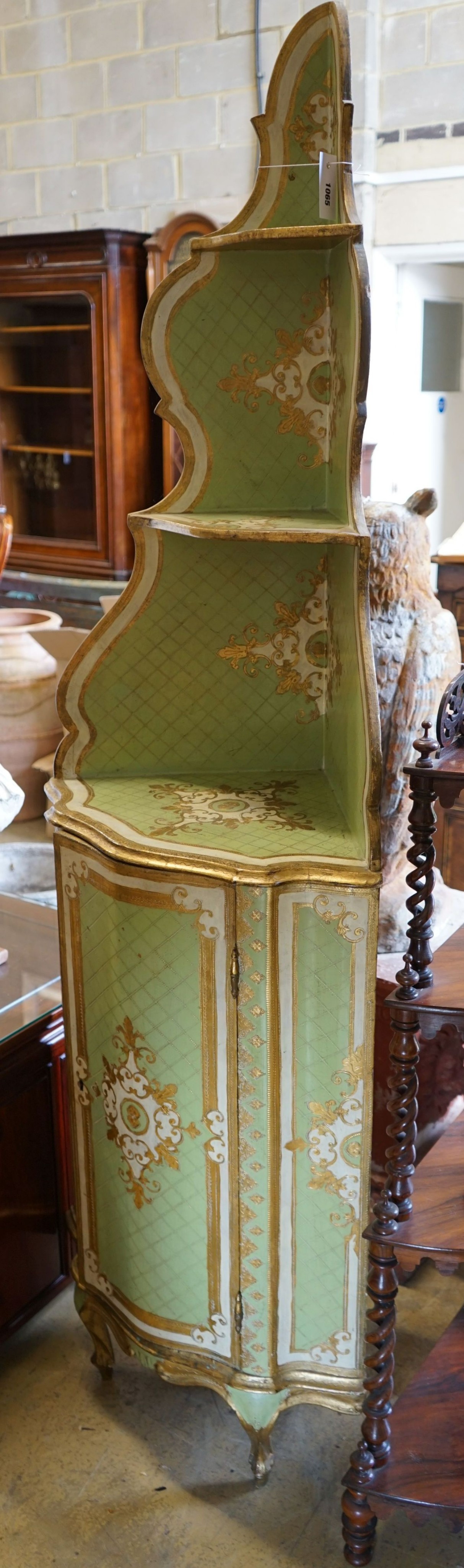 An Italian painted parcel gilt standing corner cabinet, width 57cm, depth 39cm, height 189cm